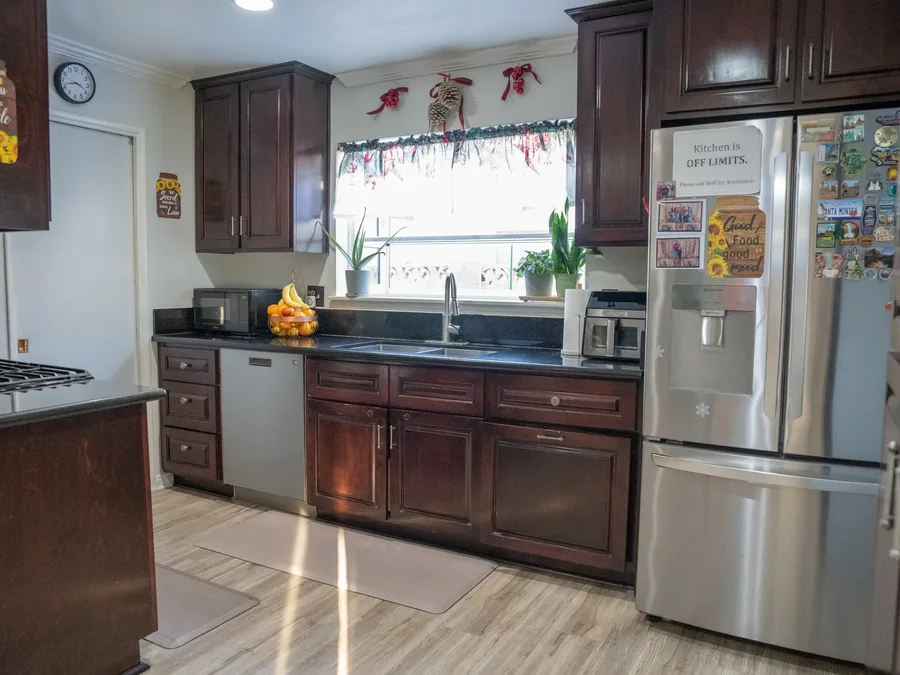 Spacious kitchen with dark wood cabinetry and granite countertops